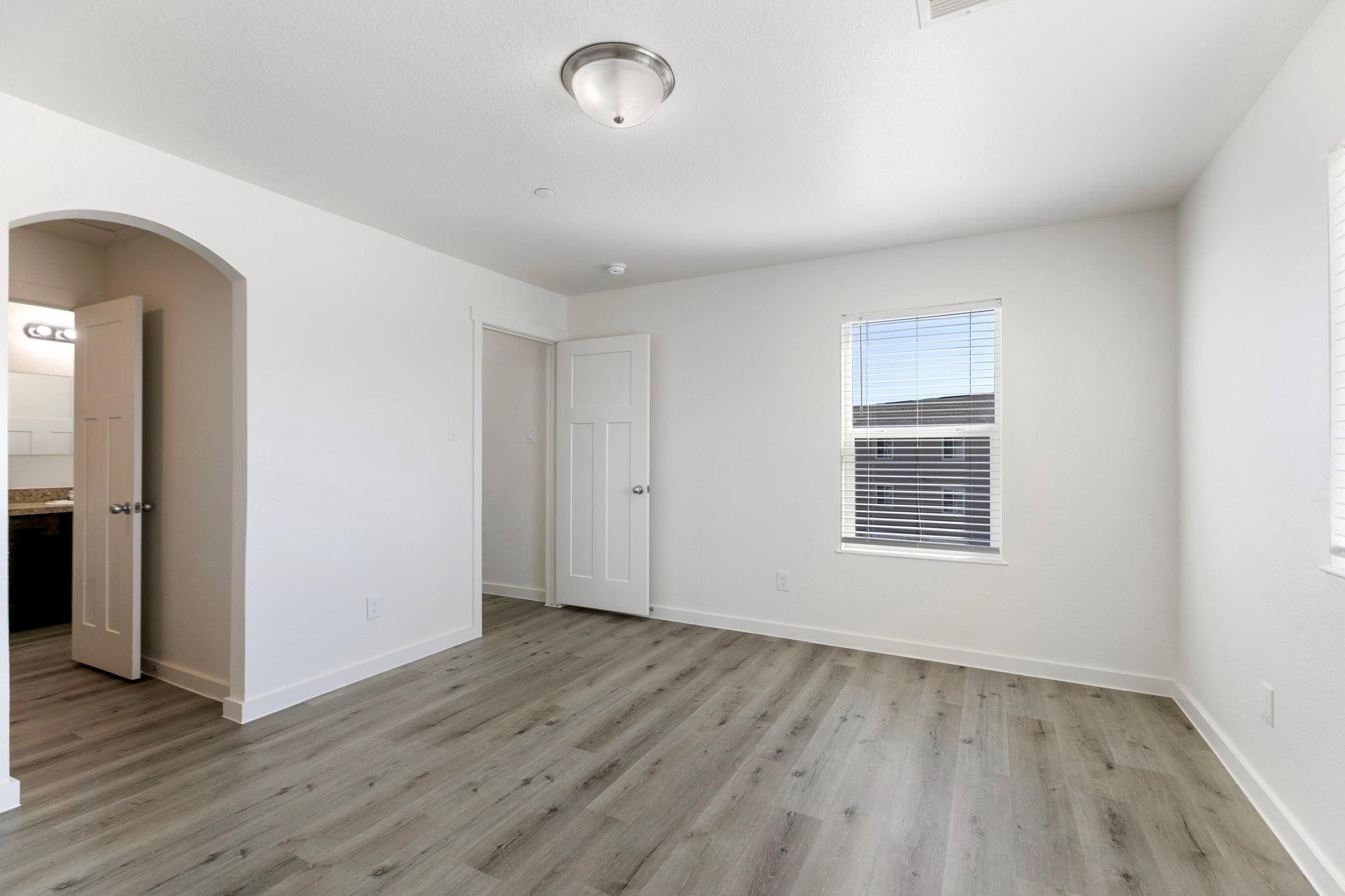 12603 Telge Road, Unit 27D Cypress, TX 77429 - Photo 17 of 27 an empty room with wooden floor and windows