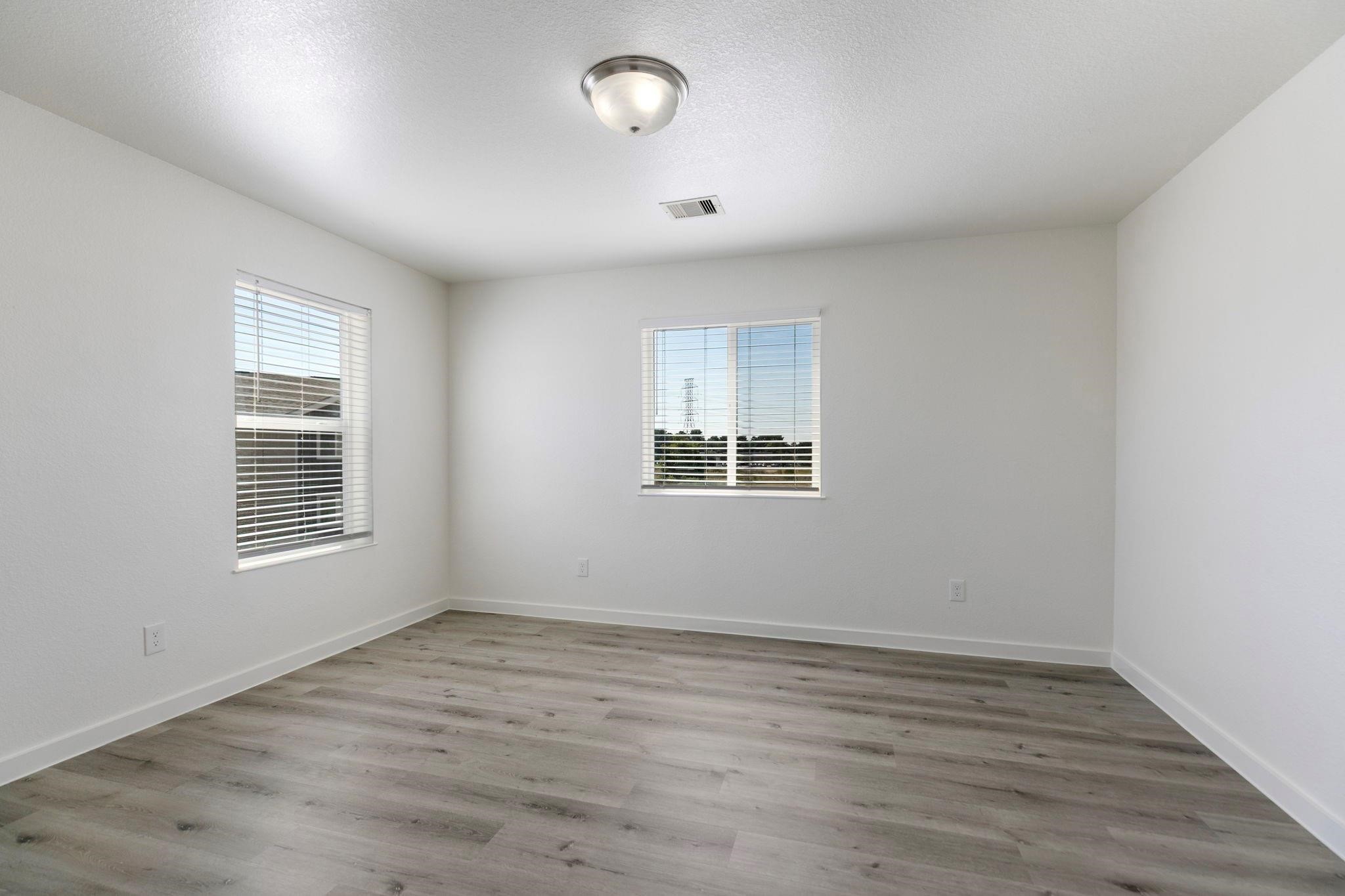 12603 Telge Road, Unit 27D Cypress, TX 77429 - Photo 17 of 27 an empty room with wooden floor and windows