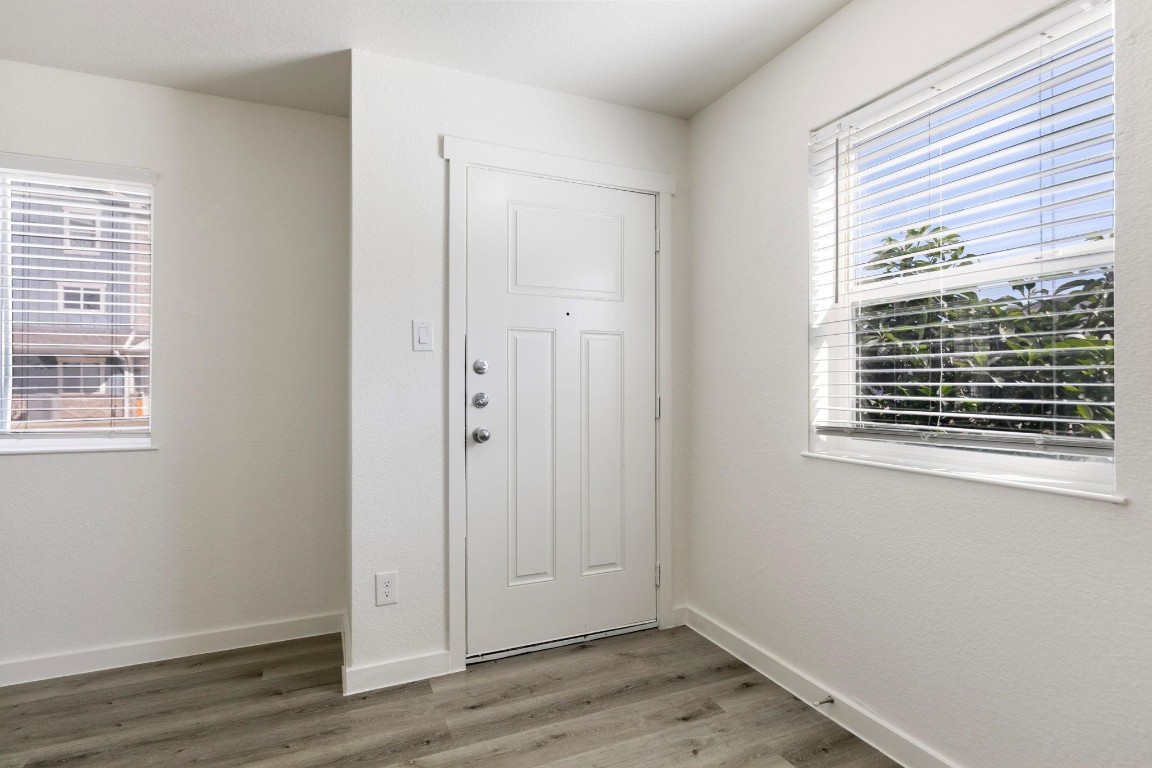 12603 Telge Road, Unit 27D Cypress, TX 77429 - Photo 5 of 27 a view of an empty room with wooden floor and a window