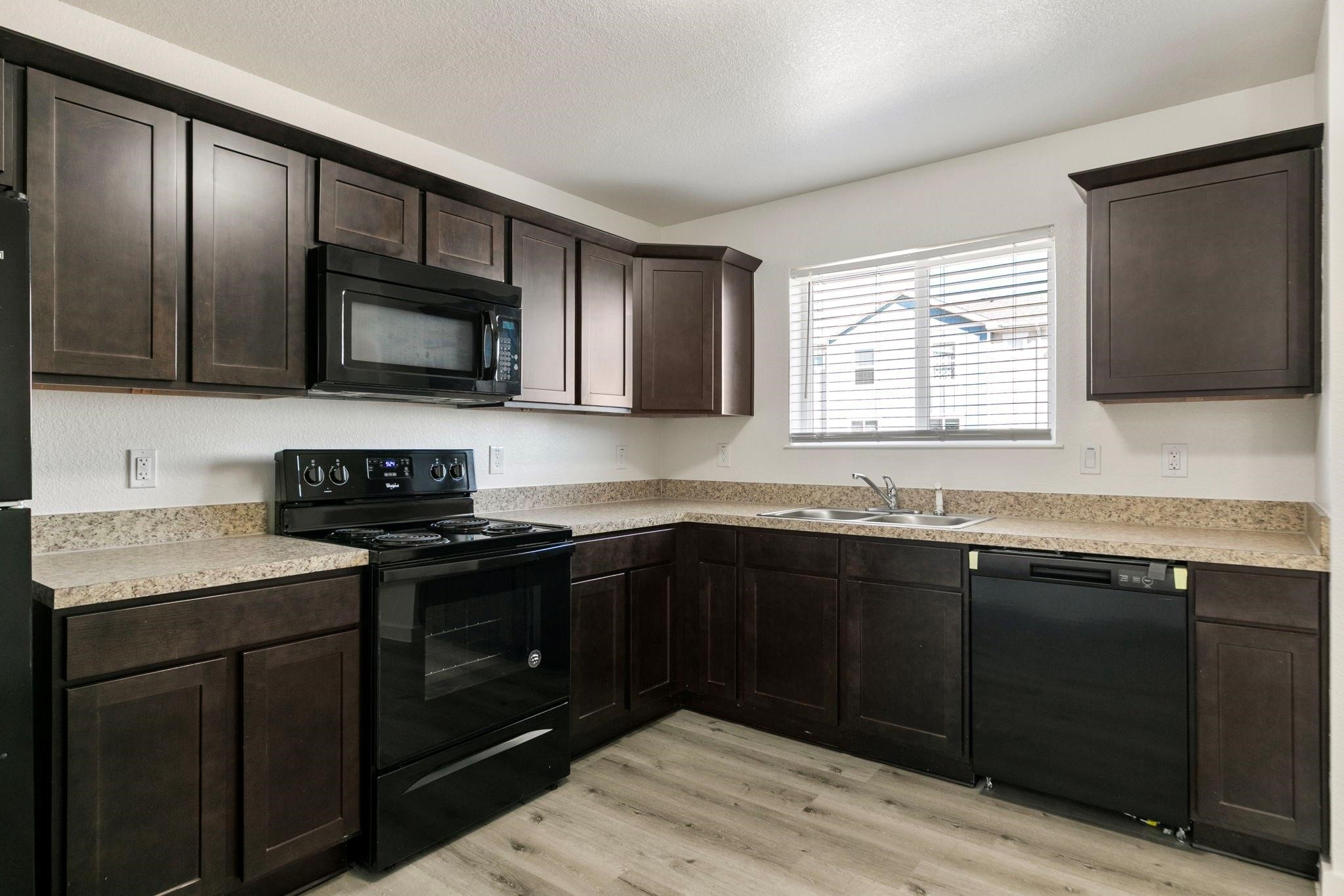 12603 Telge Road, Unit 27D Cypress, TX 77429 - Photo 8 of 27 a kitchen with granite countertop cabinets stainless steel appliances and a sink