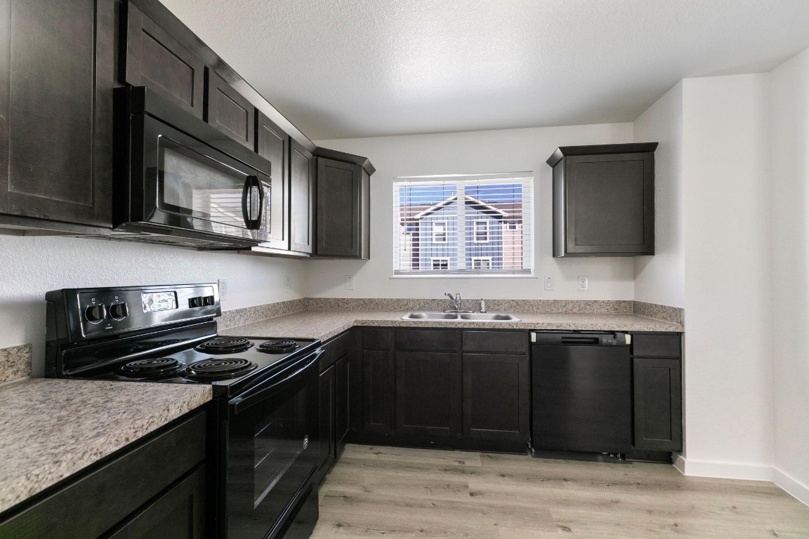12603 Telge Road, Unit 27D Cypress, TX 77429 - Photo 10 of 27 a kitchen with a sink stove and microwave