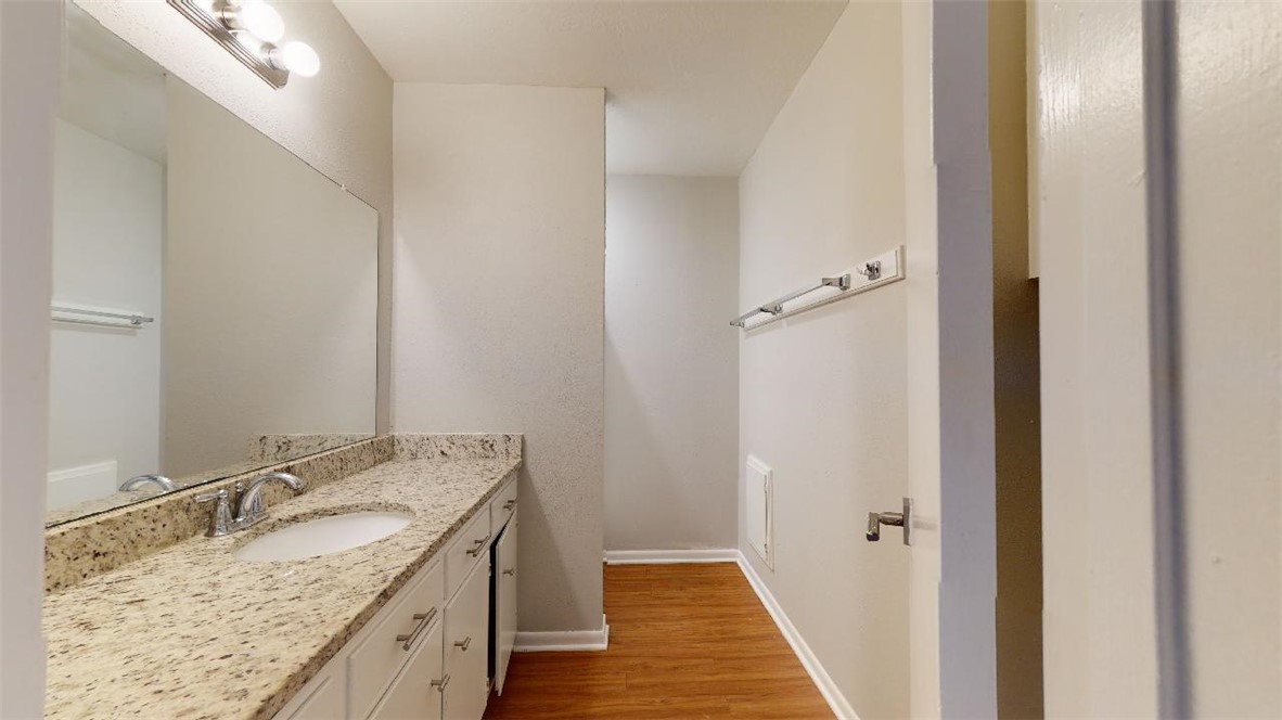 3923 Olive Street, Unit A Bryan, TX 77801 - Photo 12 of 27 a bathroom with a granite countertop sink and a mirror