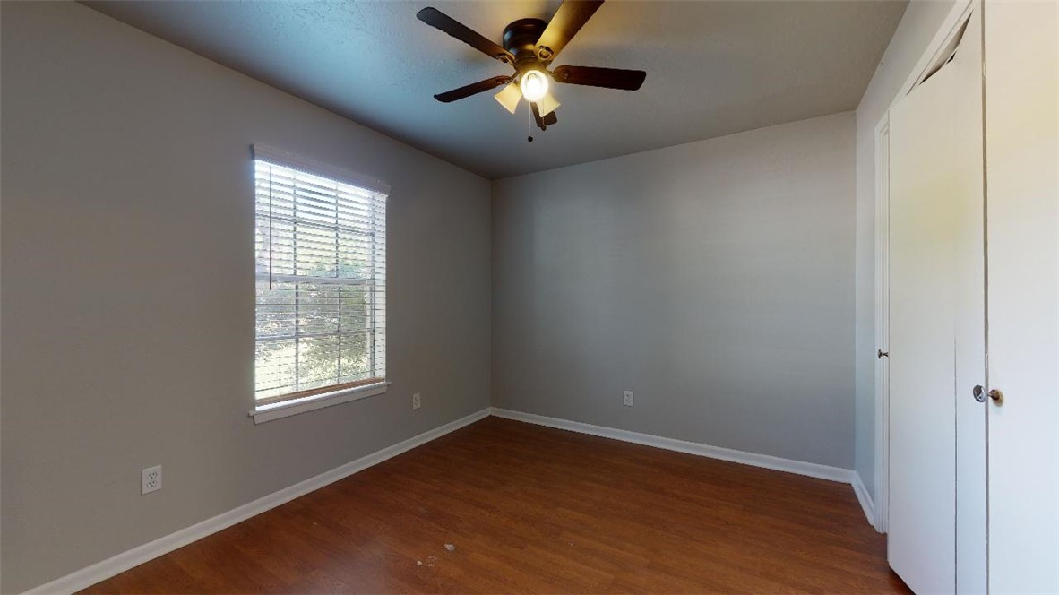 3923 Olive Street, Unit A Bryan, TX 77801 - Photo 16 of 27 wooden floor in an empty room with a window