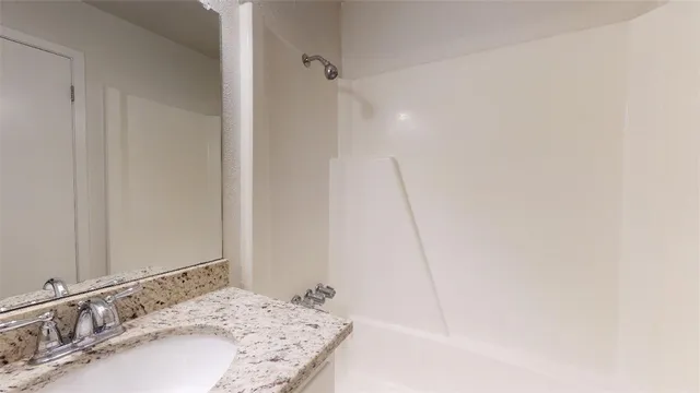 a bathroom with a sink a toilet and mirror