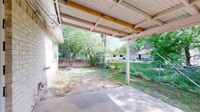 a view of a backyard with plants and a patio