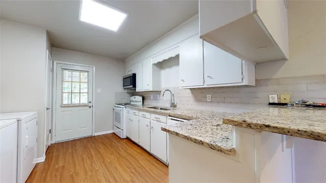 a view of kitchen and empty room
