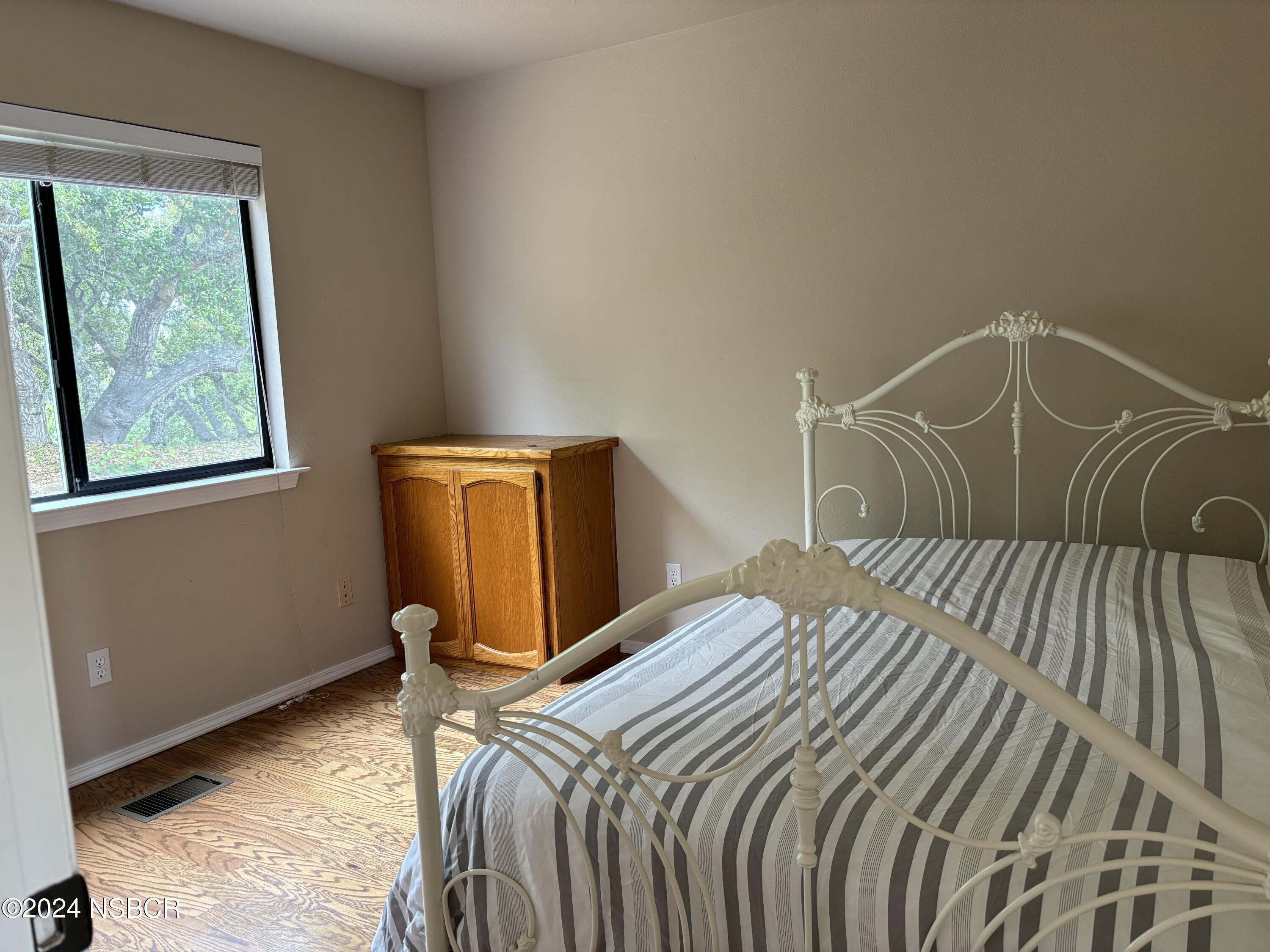 2191 Tularosa Road Lompoc, CA 93436 - Photo 50 of 67 a bedroom with a bed and wooden floor