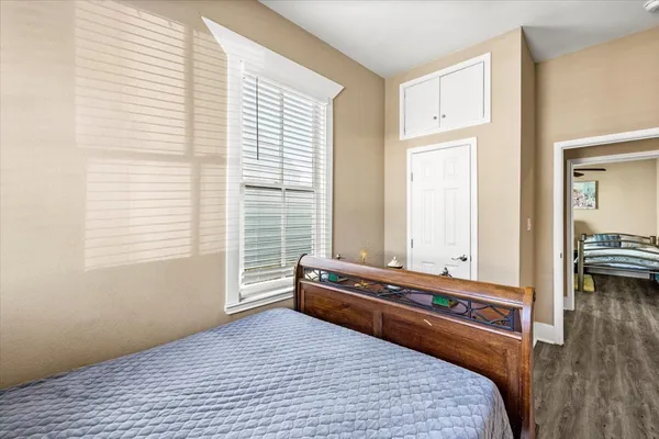 a bedroom with a bed and a window