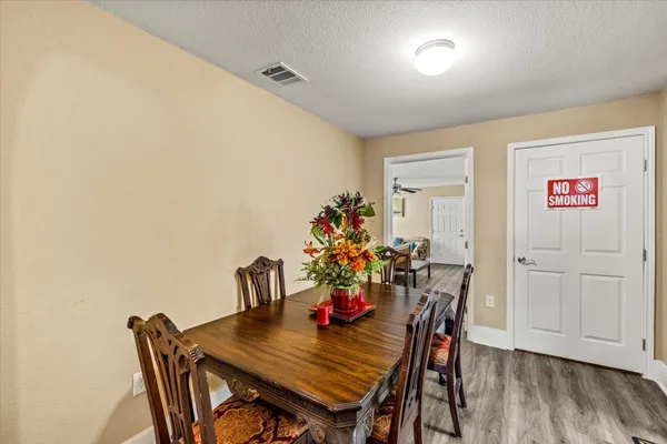 a view of a dining room with furniture and wooden floor