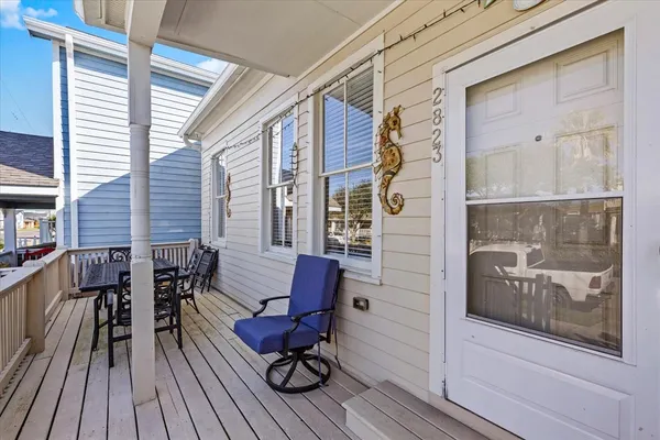 a balcony with chairs and wooden floor