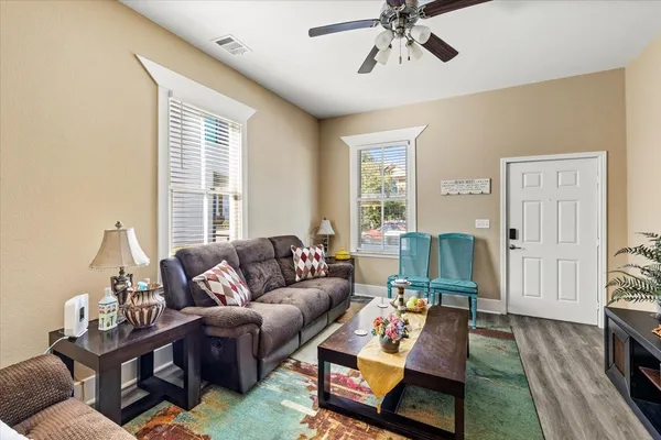 a living room with furniture and wooden floor