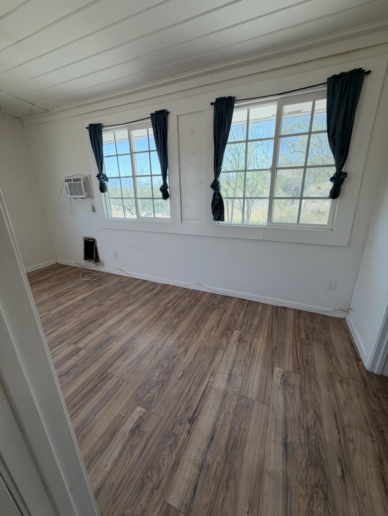 50988 Canyon Road Morongo Valley, CA 92256 - Photo 31 of 68 wooden floor in an empty room with a window