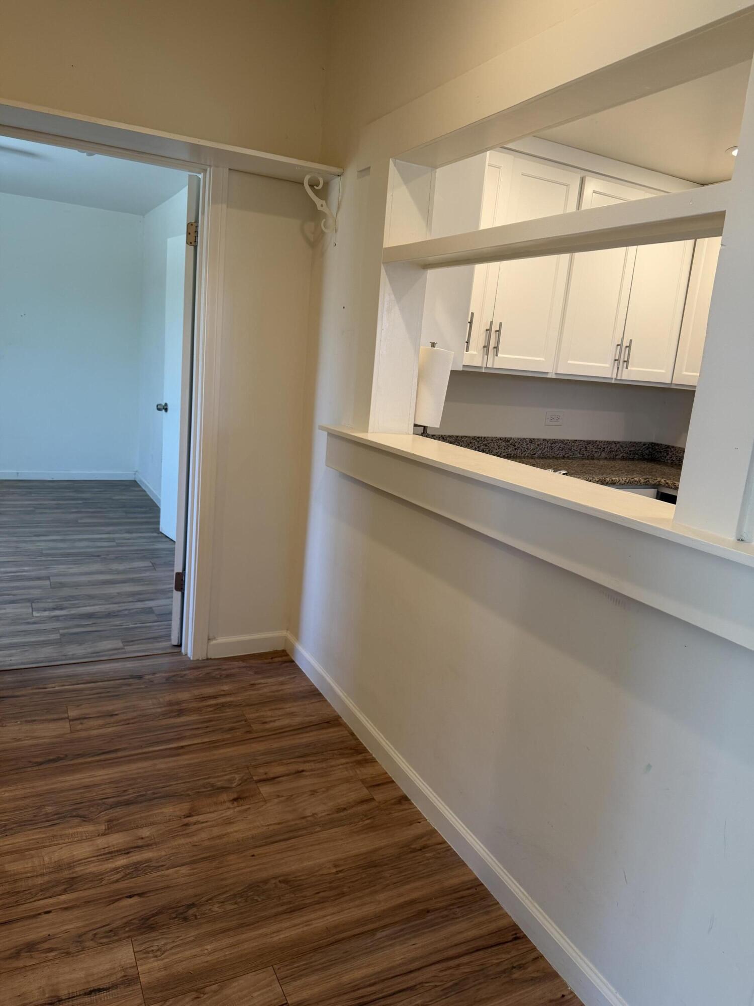 50988 Canyon Road Morongo Valley, CA 92256 - Photo 37 of 68 a view of an empty room with wooden floor and a window