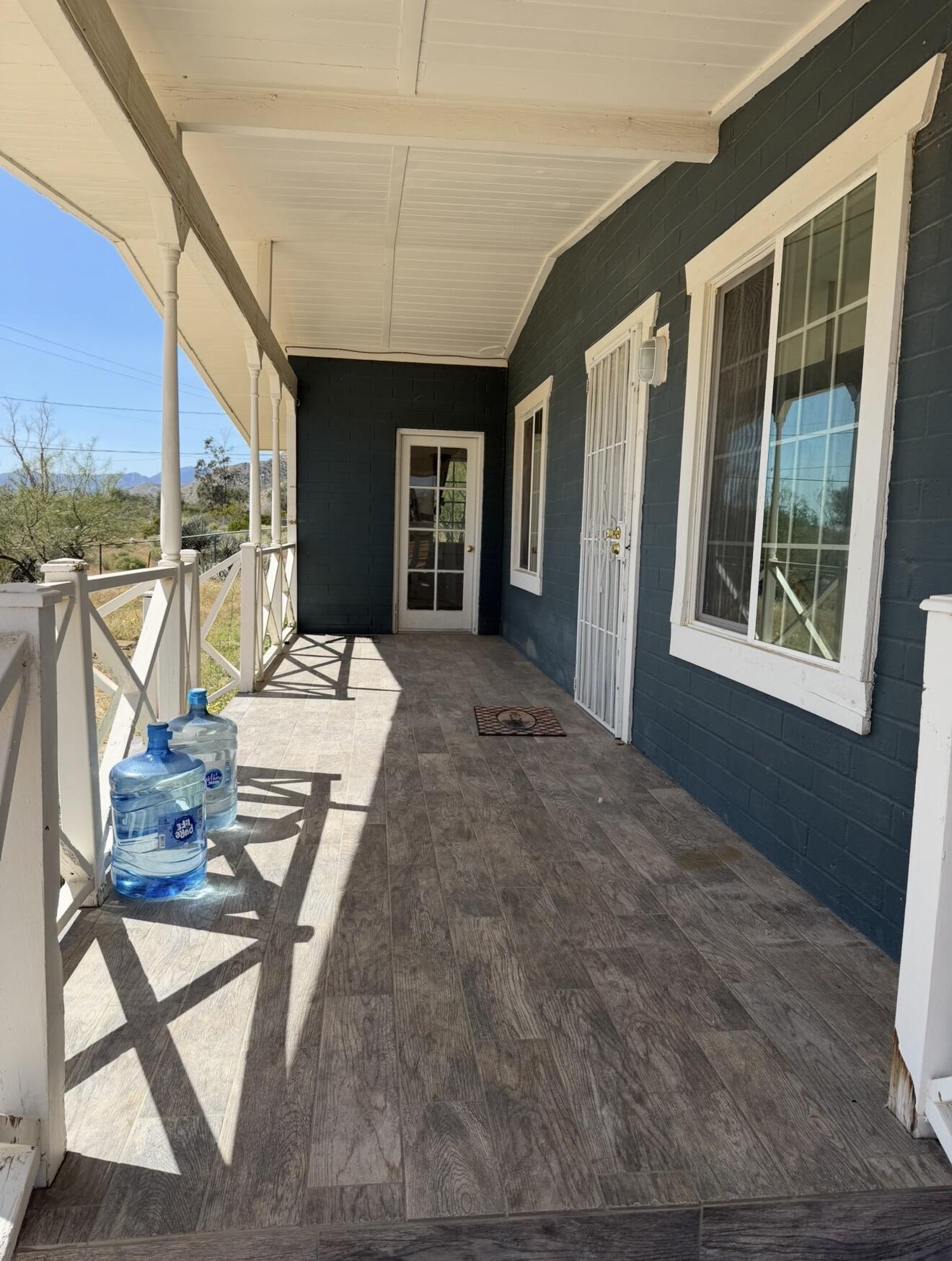 50988 Canyon Road Morongo Valley, CA 92256 - Photo 5 of 68 a view of a dining room with furniture large windows and wooden floor
