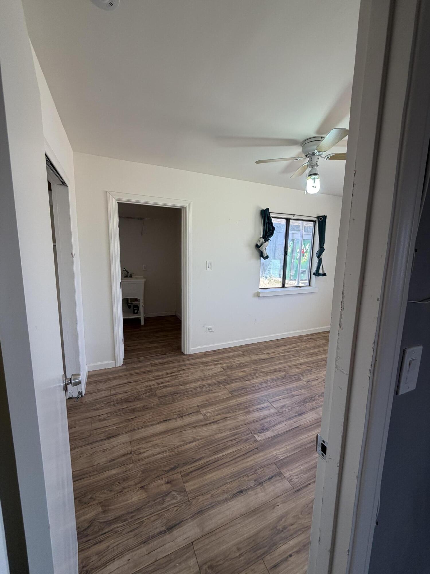50988 Canyon Road Morongo Valley, CA 92256 - Photo 51 of 68 a view of an empty room with wooden floor and a window