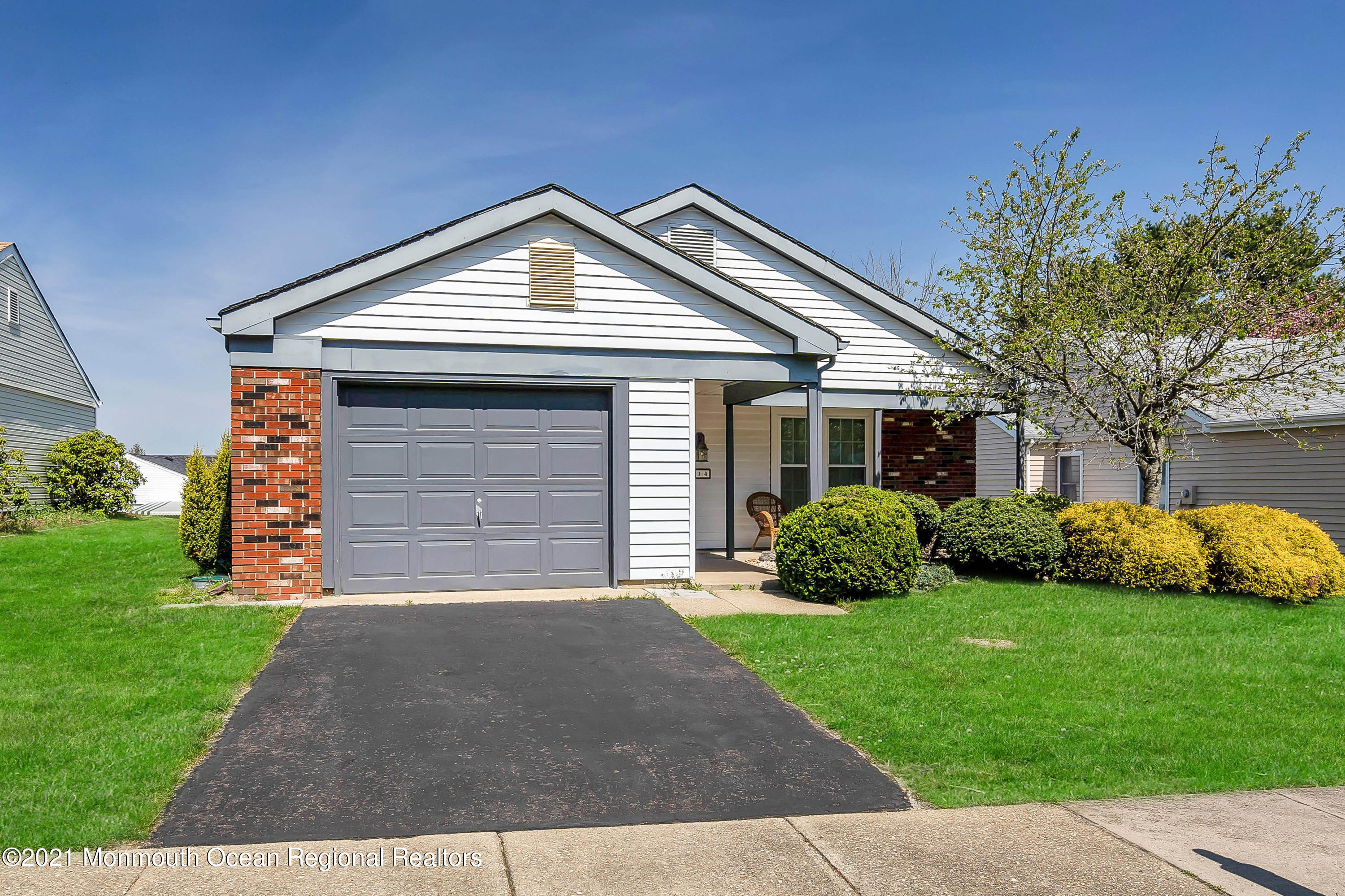 14 Maidstone Way Manchester Township, NJ 08759 - Photo 2 of 49 a front view of a house with a yard and garage