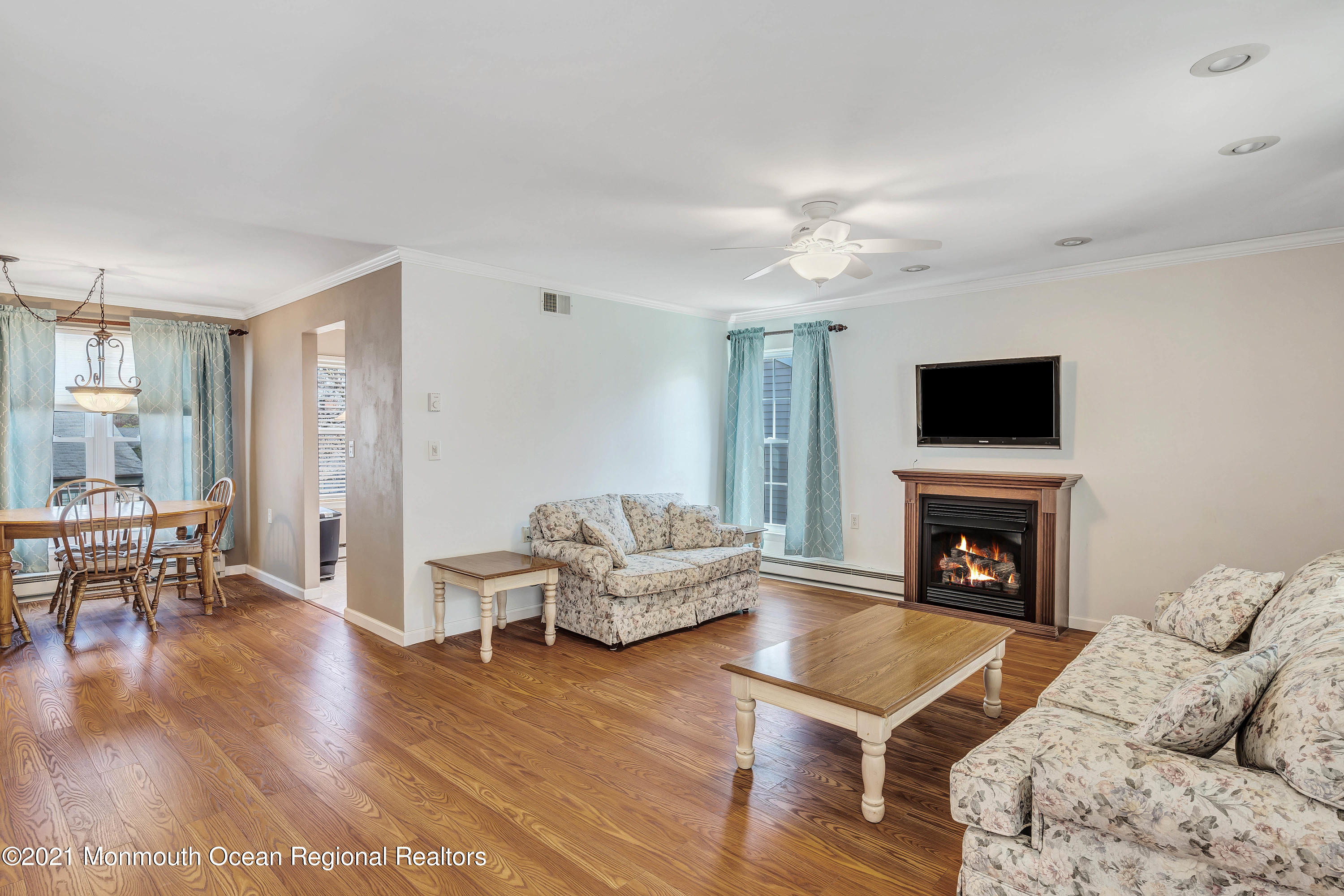 14 Maidstone Way Manchester Township, NJ 08759 - Photo 15 of 49 a living room with furniture a flat screen tv and a fireplace