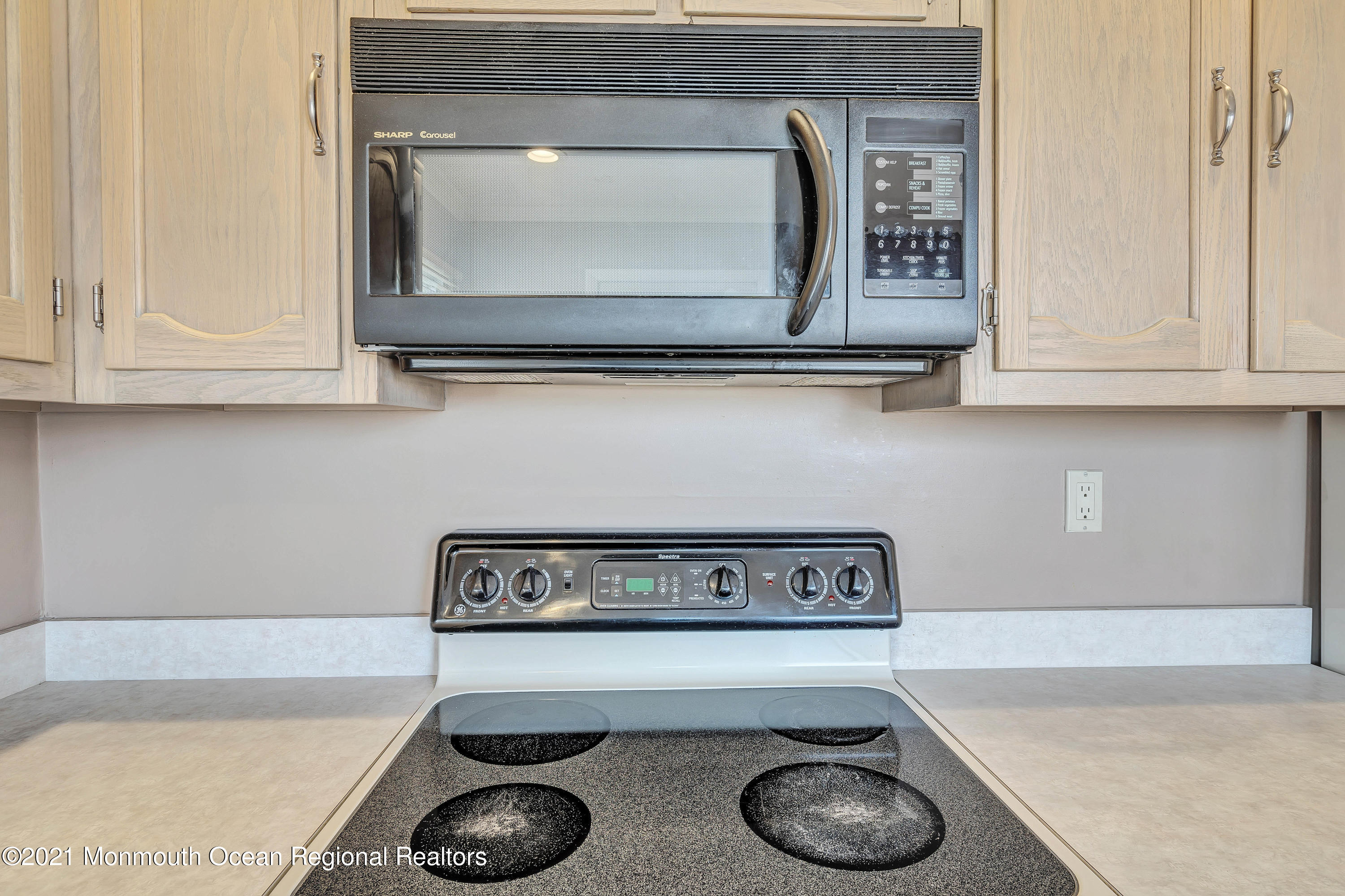 14 Maidstone Way Manchester Township, NJ 08759 - Photo 23 of 49 a close view of a stove and microwave with white cabinet