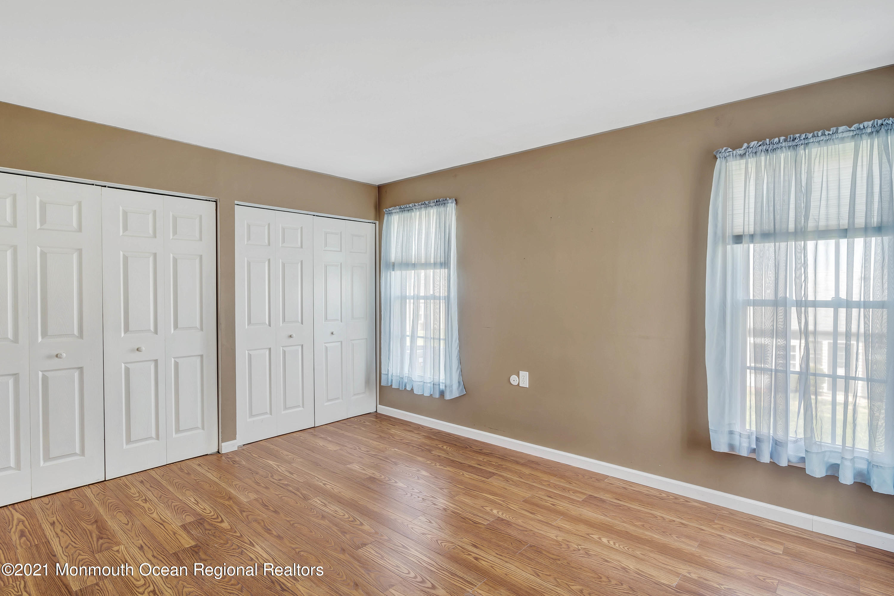 14 Maidstone Way Manchester Township, NJ 08759 - Photo 31 of 49 a view of an empty room with wooden floor and a window