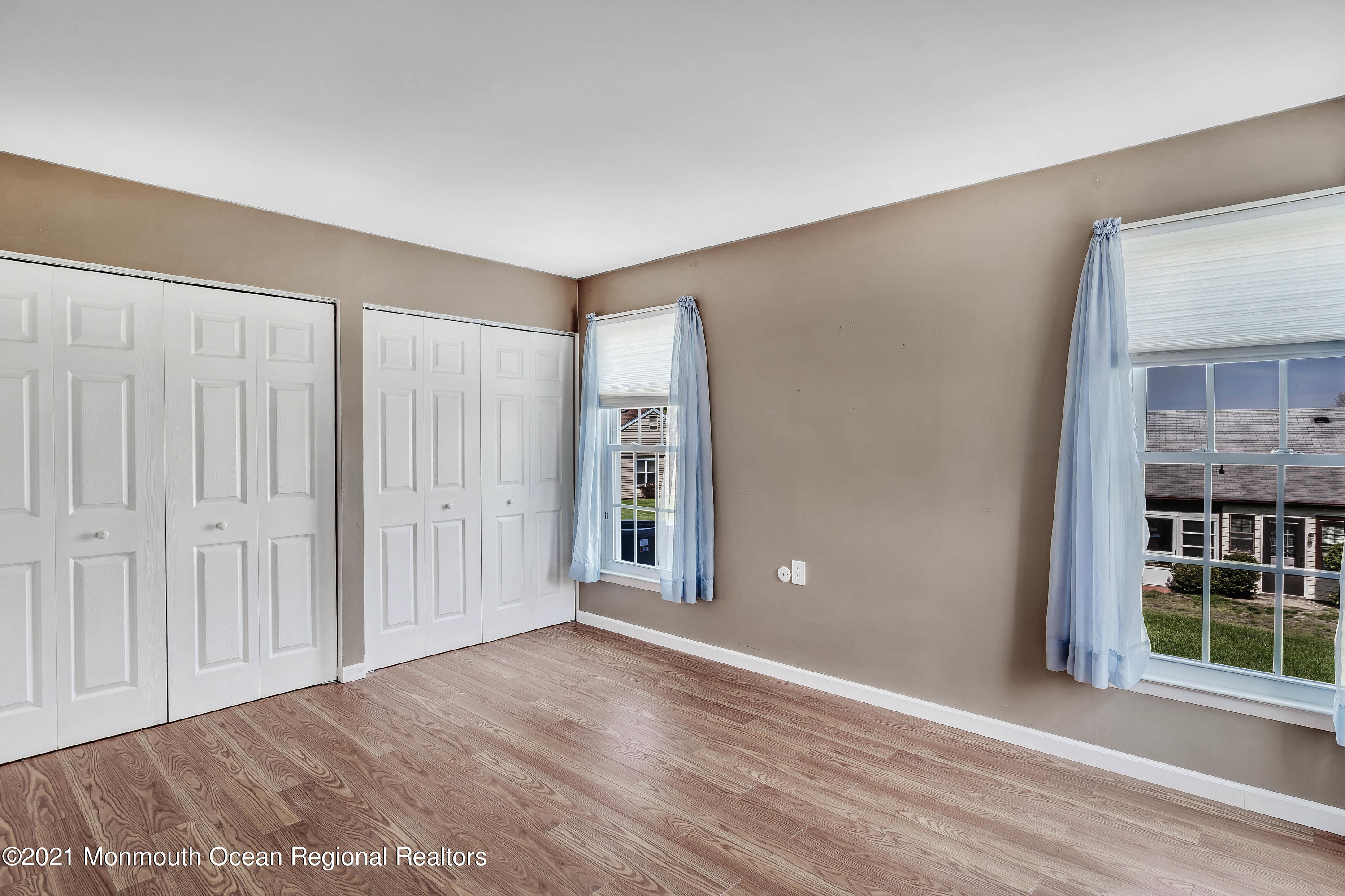 14 Maidstone Way Manchester Township, NJ 08759 - Photo 32 of 49 a view of an empty room with wooden floor and a window