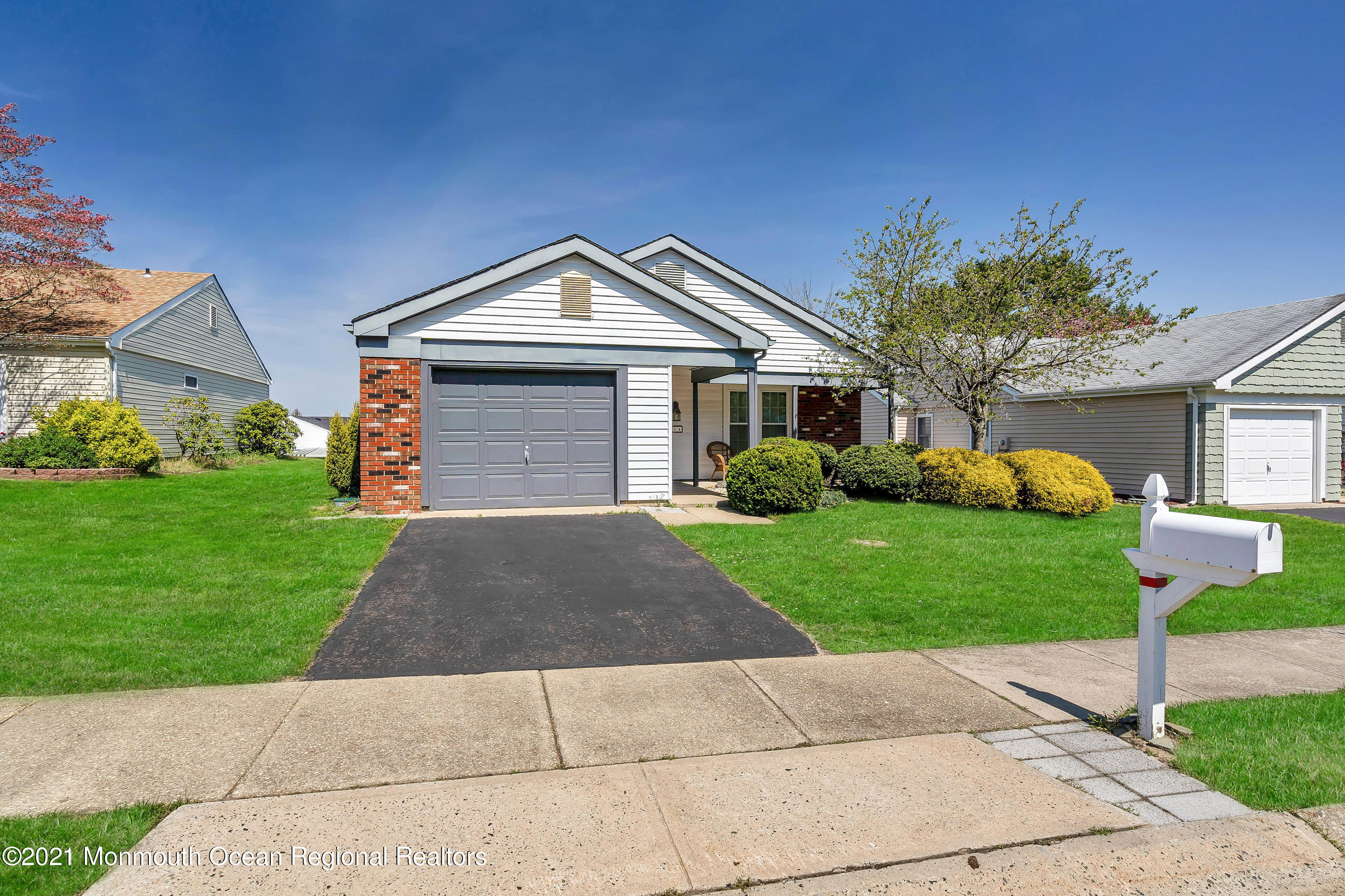 14 Maidstone Way Manchester Township, NJ 08759 - Photo 6 of 49 a front view of a house with a yard and garage