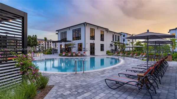 a view of swimming pool with outdoor seating and plants
