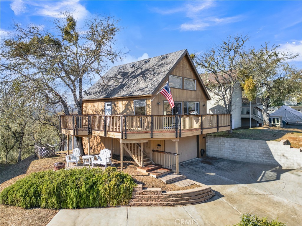 a view of a house with backyard porch and sitting area