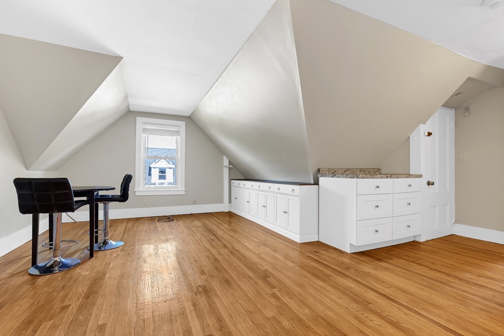 28 Evergreen Street, Unit 3 Boston, MA 02130 - Photo 3 of 16 a view of a workspace with furniture and a wooden floor