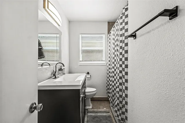 a bathroom with a sink toilet and shower