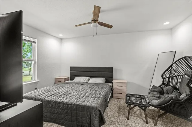 a bedroom with a bed and windows