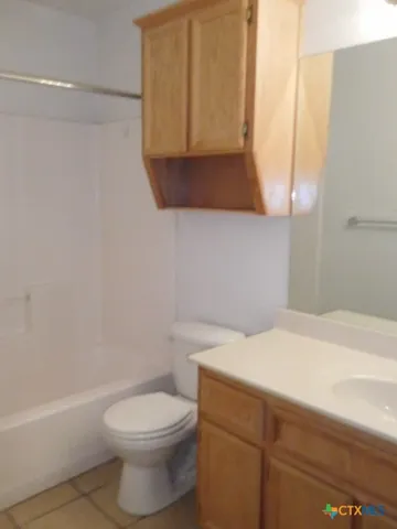 a bathroom with a sink a toilet and vanity