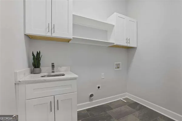 a bathroom with a sink and cabinets
