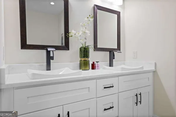 a bathroom with a sink vanity and a mirror