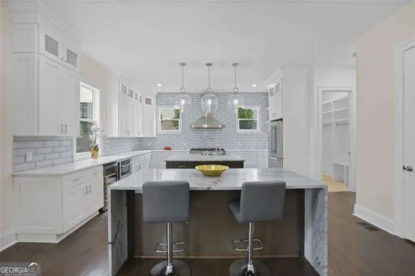 a kitchen with a sink cabinets and window