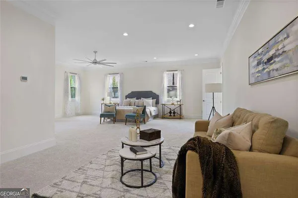 a living room with furniture a couch and potted plant