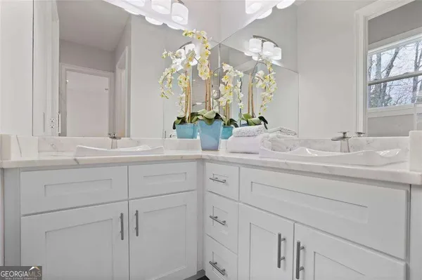 a bathroom with a sink vanity and a mirror