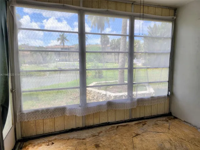 a view of a glass door with a yard