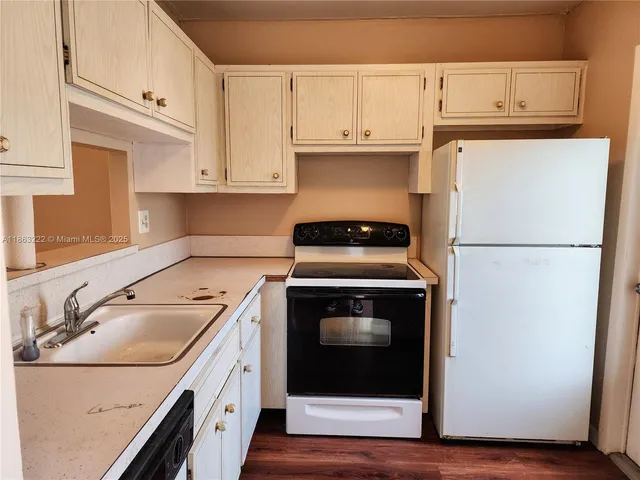 a kitchen with cabinets and steel stainless steel appliances
