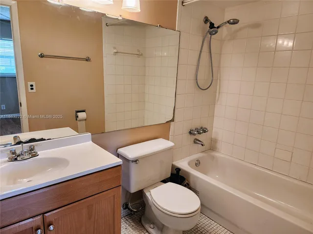 a bathroom with a sink toilet vanity and shower
