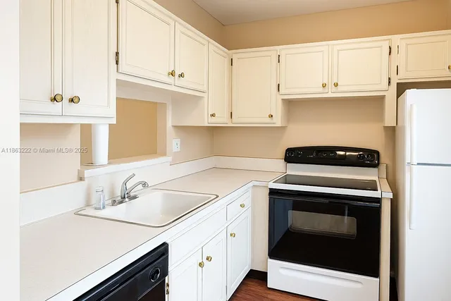 a kitchen with cabinets appliances and a sink