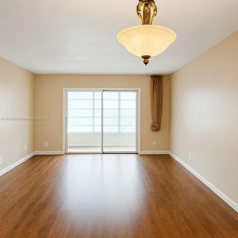 a view of an empty room with glass door