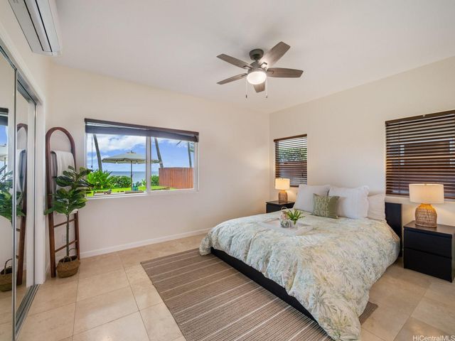 a bedroom with two beds and a lamp