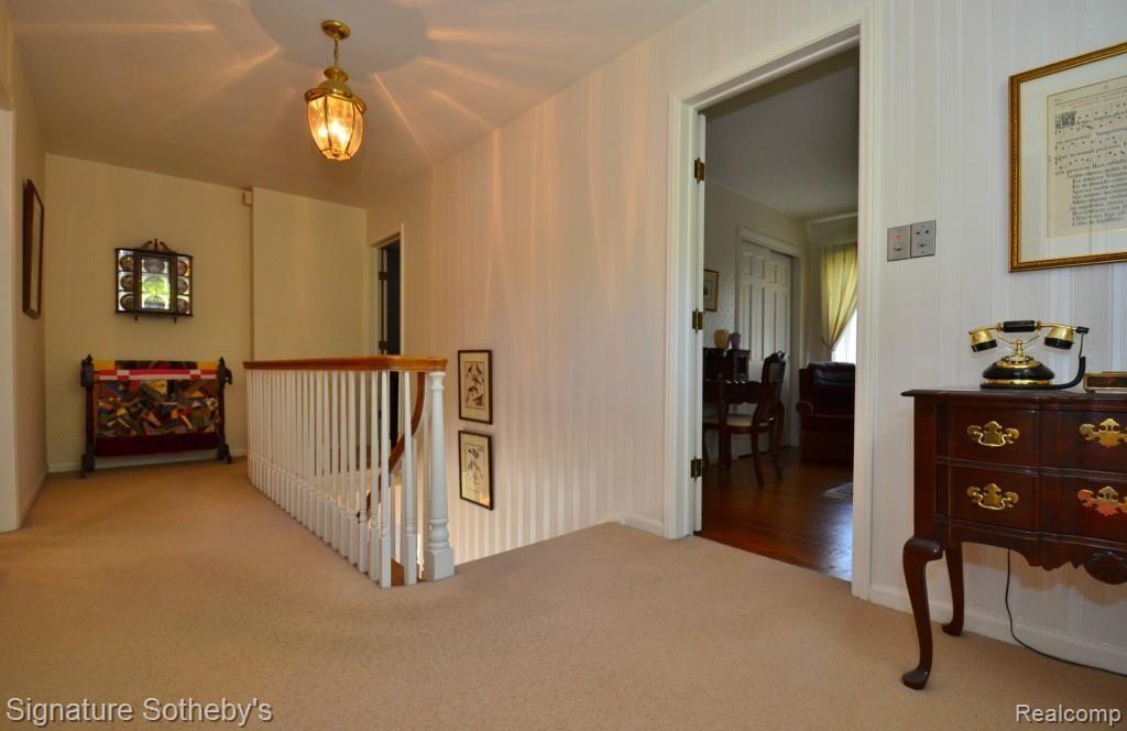 709 Tottenham Road Birmingham, MI 48009 - Photo 12 of 28 Upstairs Hallway with Hardwood Floor Under Carpet