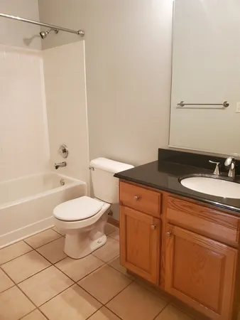 a bathroom with a toilet and a bath tub