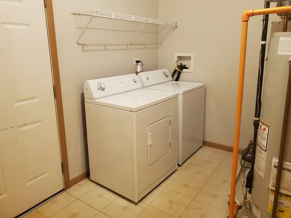 a front view of a house with a tree