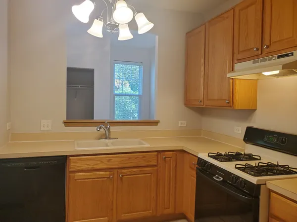 a kitchen with stainless steel appliances a stove a sink and a microwave