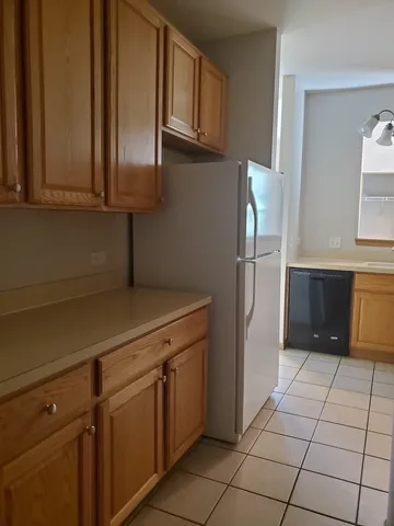a kitchen with stainless steel appliances a refrigerator and cabinets