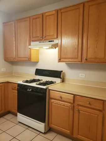 a kitchen with granite countertop cabinets and stainless steel appliances