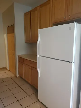 a white refrigerator freezer sitting in a kitchen