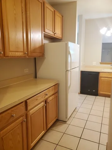 a kitchen with a refrigerator and cabinets